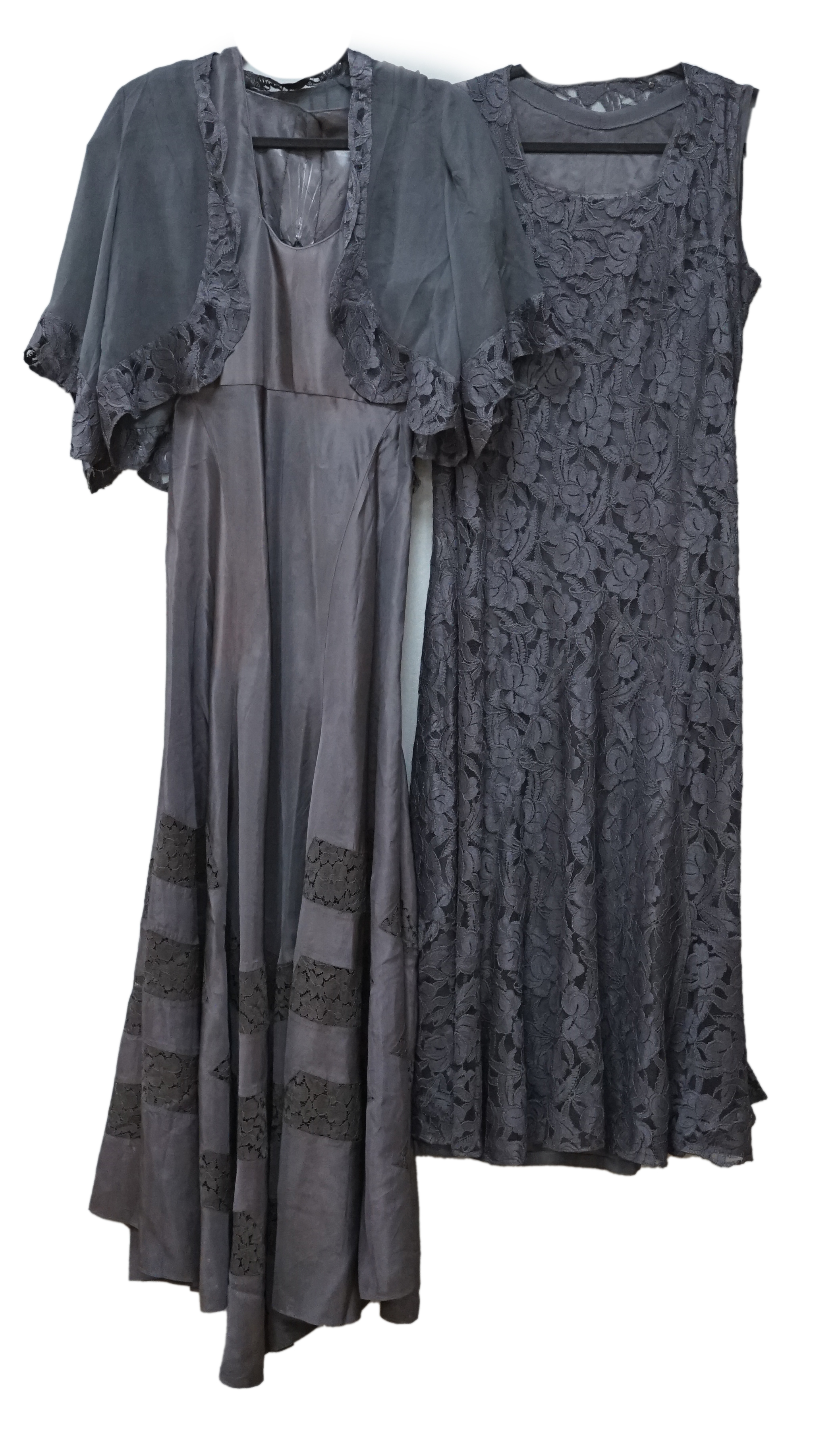 A 1930s black lace evening dress and matching jacket, together with a black taffeta and lace evening dress, the lace dress with bias cut panels and sheer lace trimmed sleeved jacket, the taffeta dress with lace insertion